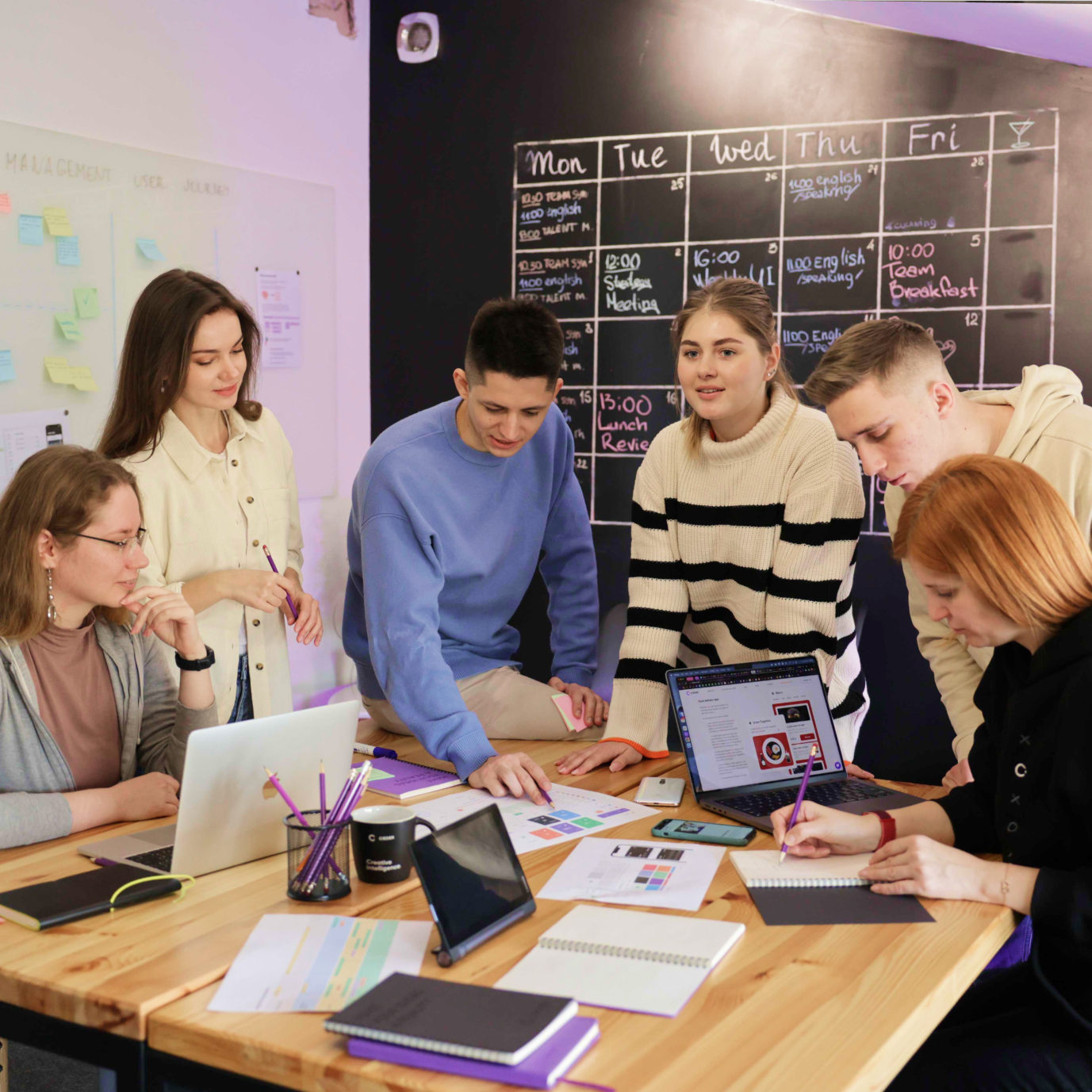 What is a dedicated design team model?