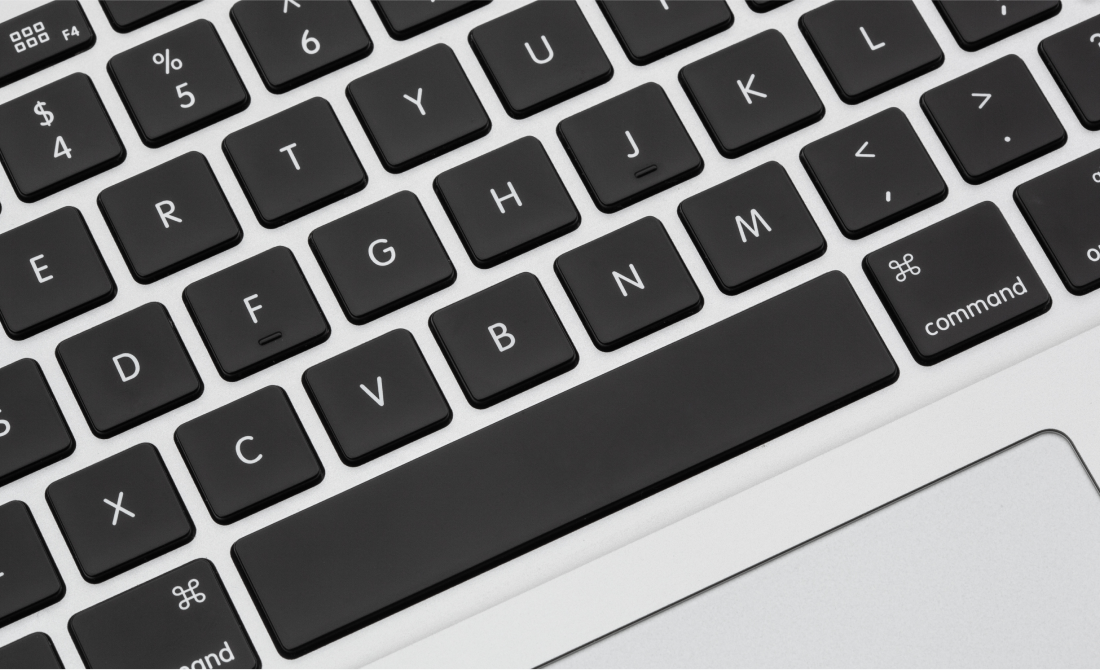 Close-up of a Macbook keyboard with rounded buttons.